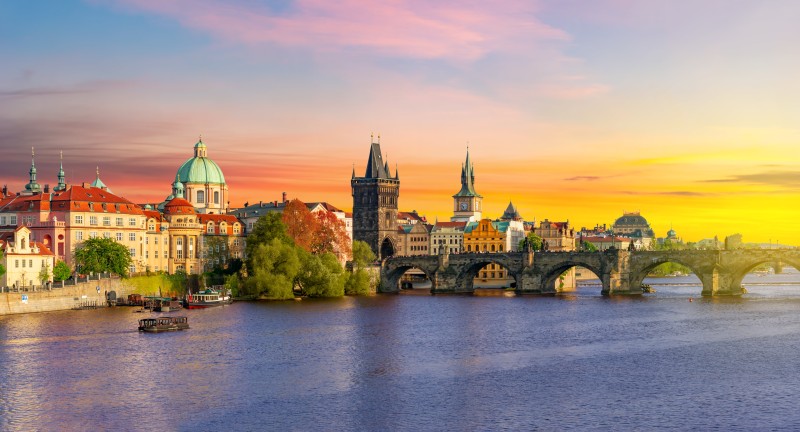 Old Town Bridge Tower and Charles bridge over Vltava river at sunset