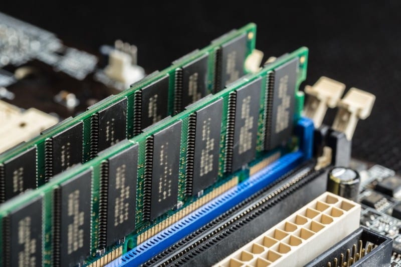 Close-up view of computer RAM modules installed on a motherboard, showcasing the intricate details of memory chips and circuit connections.