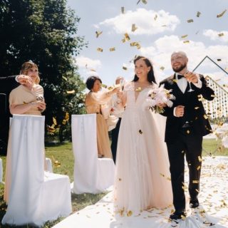 10 Pro Steps for Filmmakers: Cinematic Wedding Videos That Couples Love. A joyful bride and groom celebrate their wedding day surrounded by confetti in a beautiful outdoor setting.