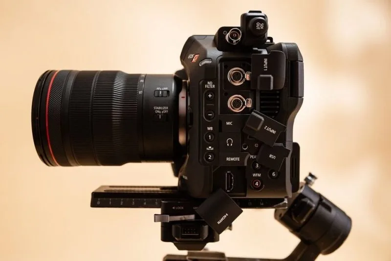 A close-up of a professional camera with a large lens, featuring various controls and inputs, ideal for photography and videography.