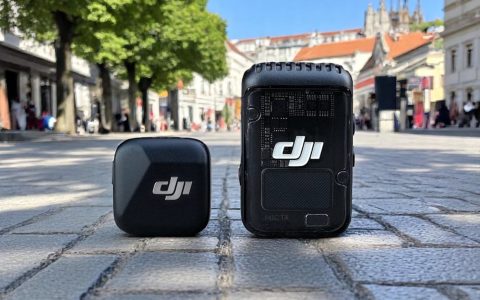 DJI Mic 2 vs Mic Mini: 6-Month Real-World Comparison Review. A DJI wireless microphone system displayed on a cobblestone street, featuring a compact transmitter and receiver.